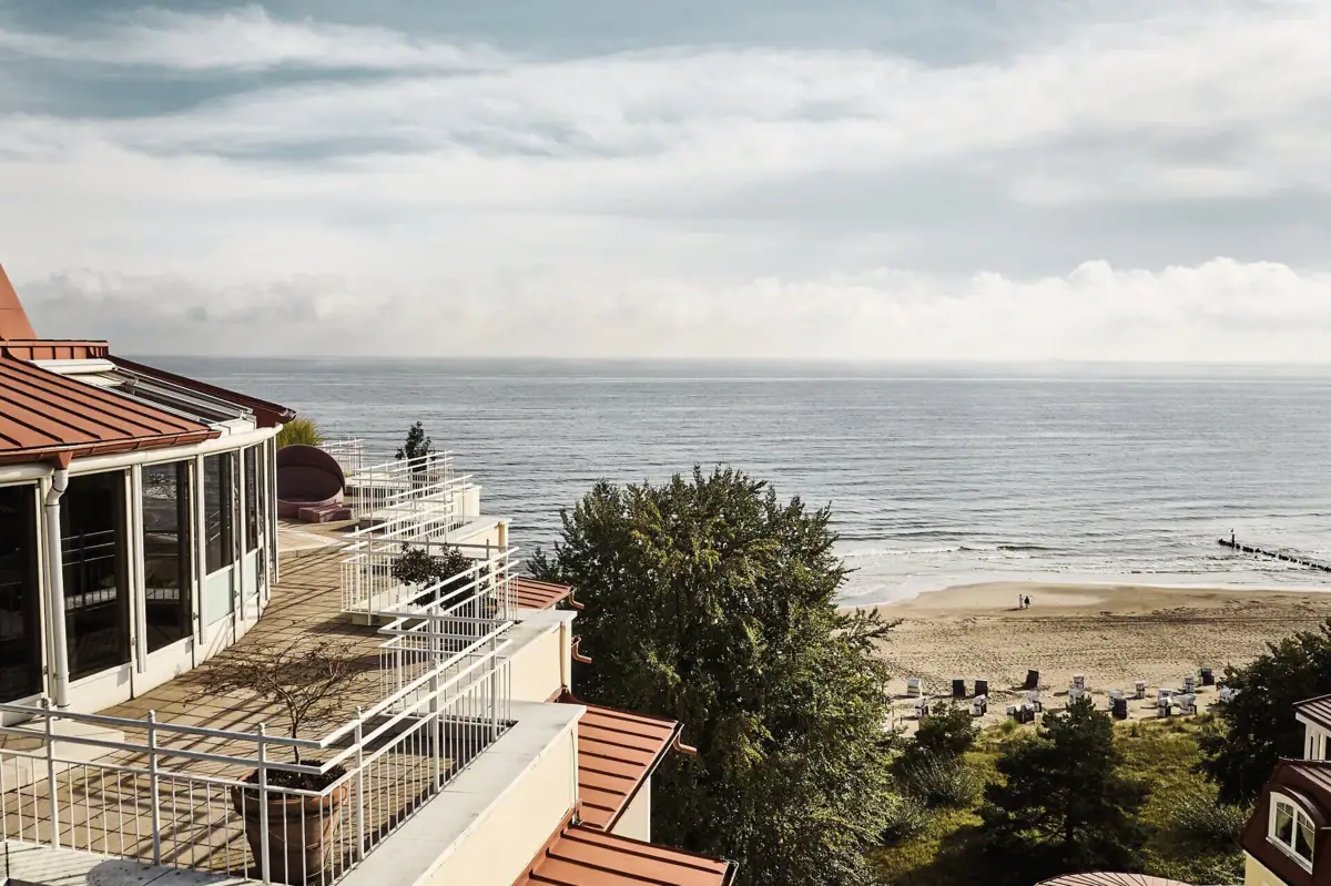 Ein Strand mit einem Gebäude und einem Gewässer.