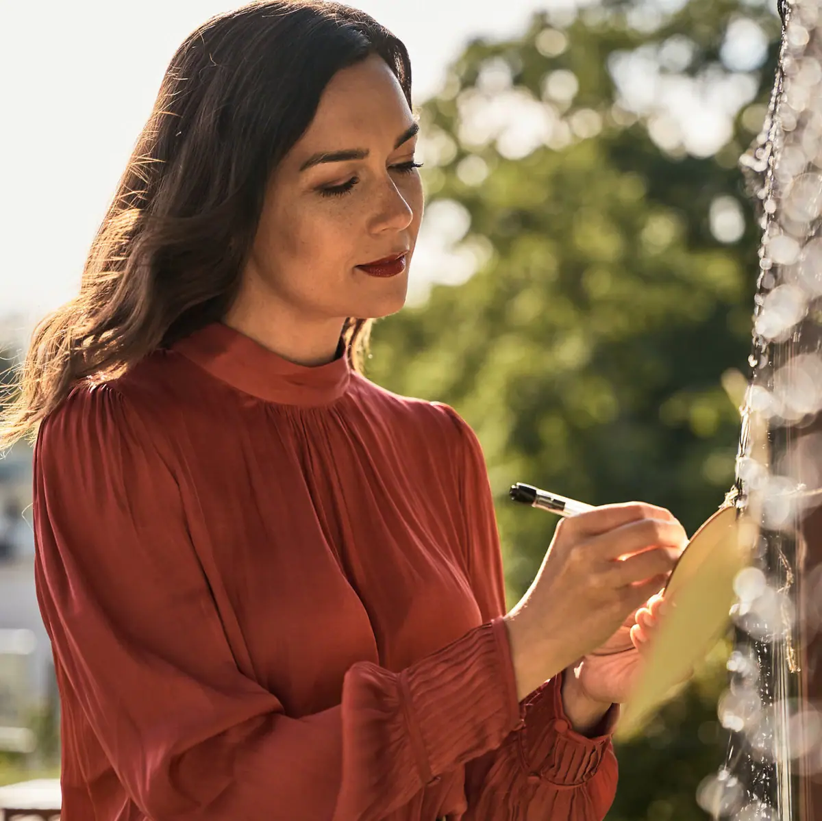Frau notiert etwas Eine Frau schreibt in ein Notizbuch.