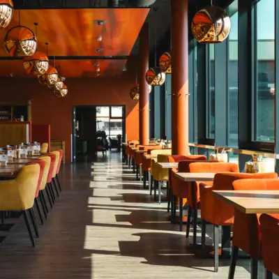 Gastronomie im aja Grömitz Ein Raum mit Tischen und Stühlen.