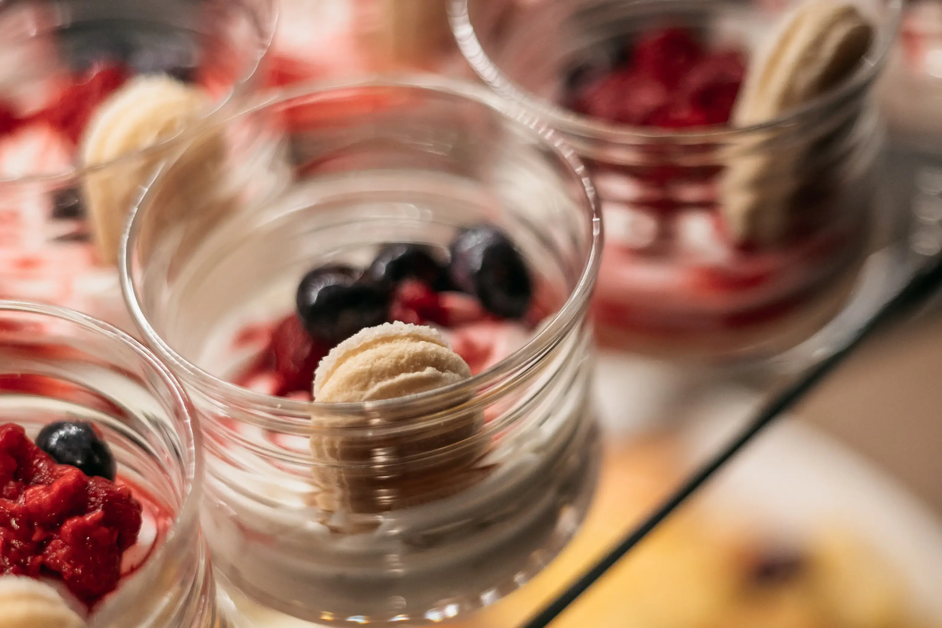 Eine Gruppe von Dessertgläsern mit süßen Leckereien und Früchten.