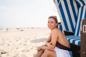 Eine Frau sitzt in einem Strandkorb.