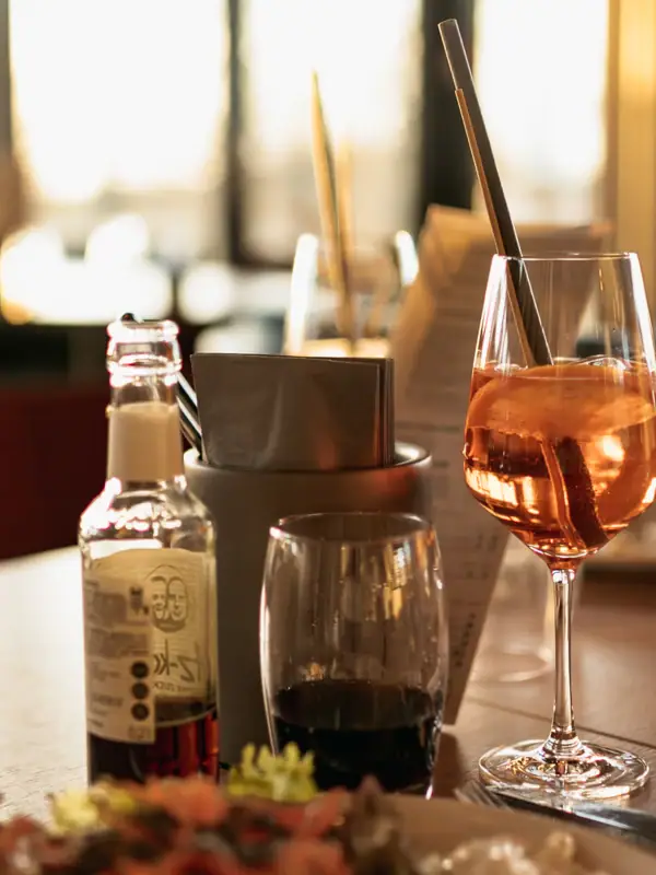 Essen und Trinken Ein Tisch mit einem Teller Essen und einem Glas Getränk.