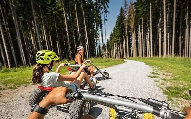 Group of people mountain karting on a gravel road.