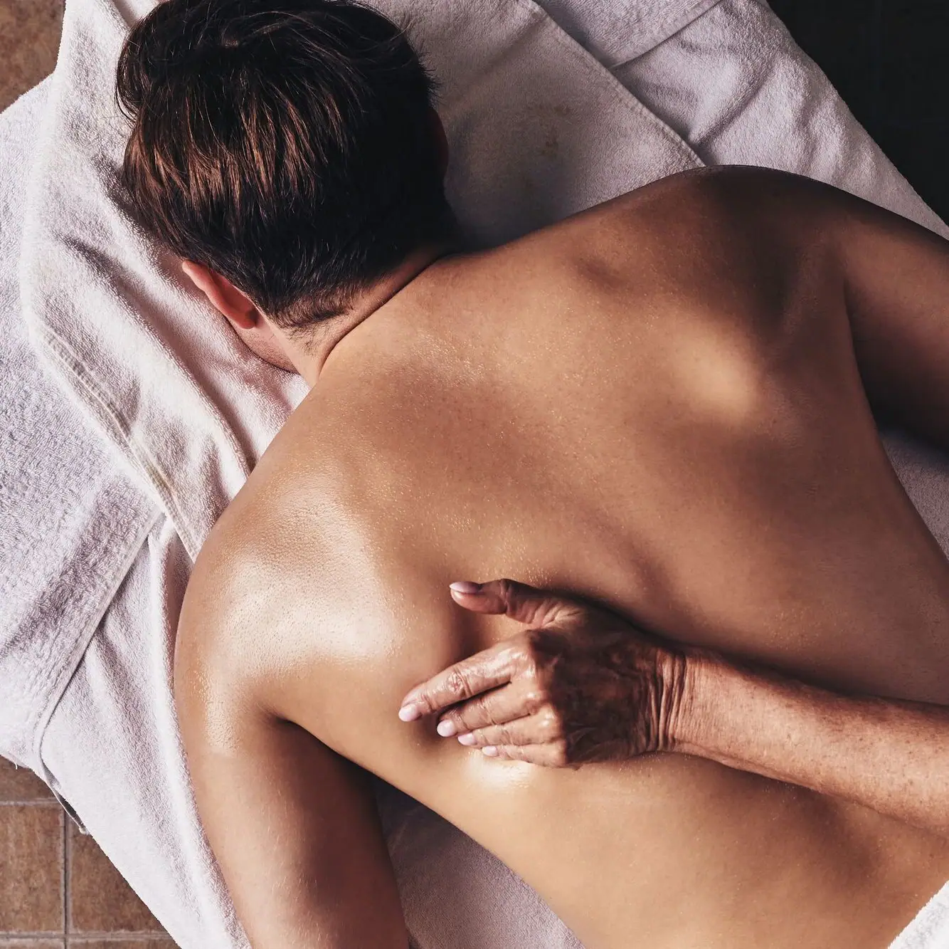 Eine Person liegt mit dem Rücken auf einem Handtuch.