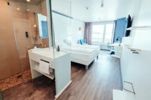 Ein Raum mit zwei Betten und einer Dusche.