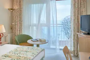 Ein Zimmer mit einem Bett und einem Fernseher.