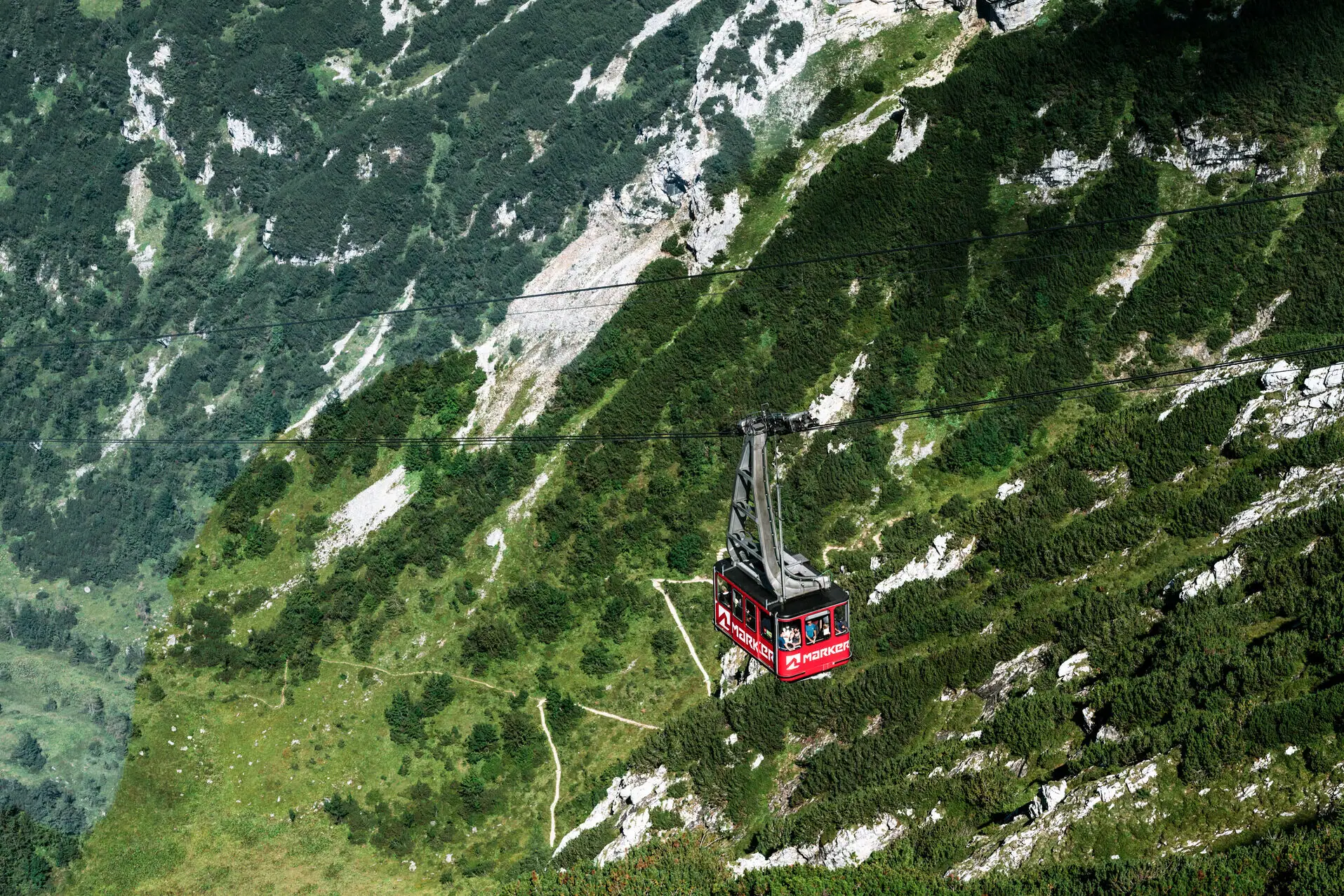 Bergbahn Garmisch Eine rote Gondel einer Seilbahn in den Bergen.