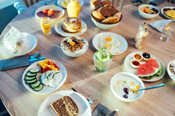 Frühstück Ein Frühstückstisch mit Tellern voller Speisen und Getränken.