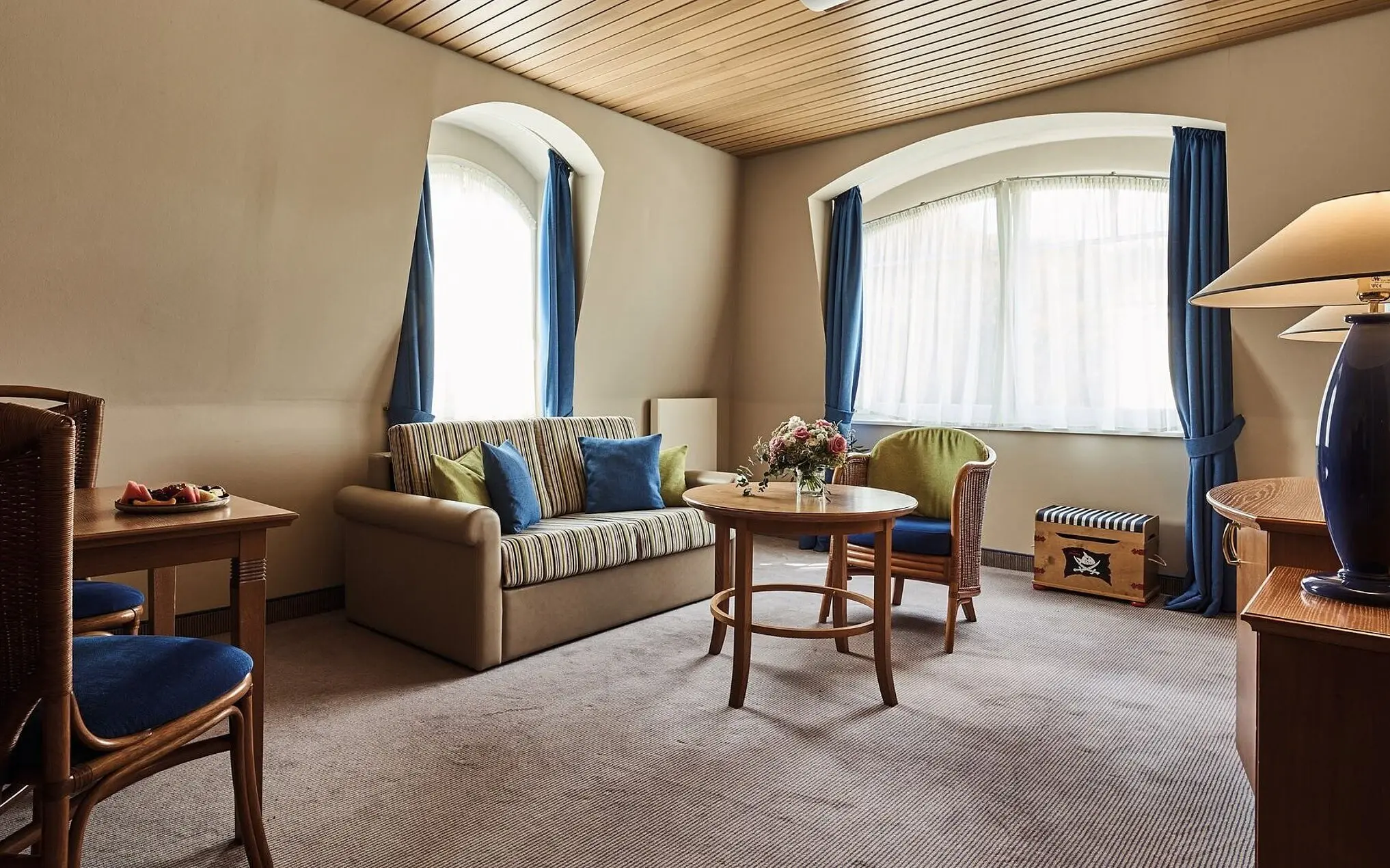 A living room with a sofa and chairs.