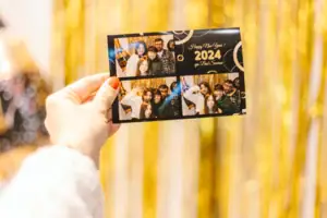 Fotoautomat Eine Hand hält eine Karte mit einer Gruppe von Menschen.