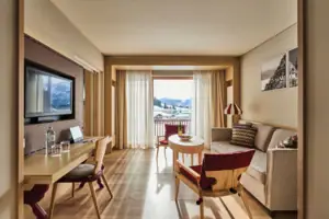 Ein Raum mit einem Tisch, Stühlen und einem Fernseher.