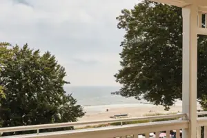 Terrasse mit Stühlen und einem Tisch darauf.