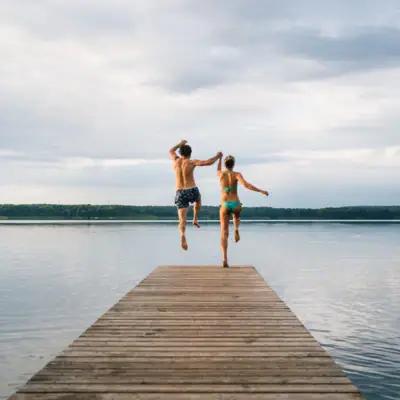 Ein Mann und eine Frau springen ins Wasser.
