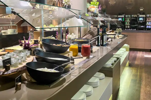 Buffettisch mit Tellern und Schüsseln voller Essen in einem Restaurant.