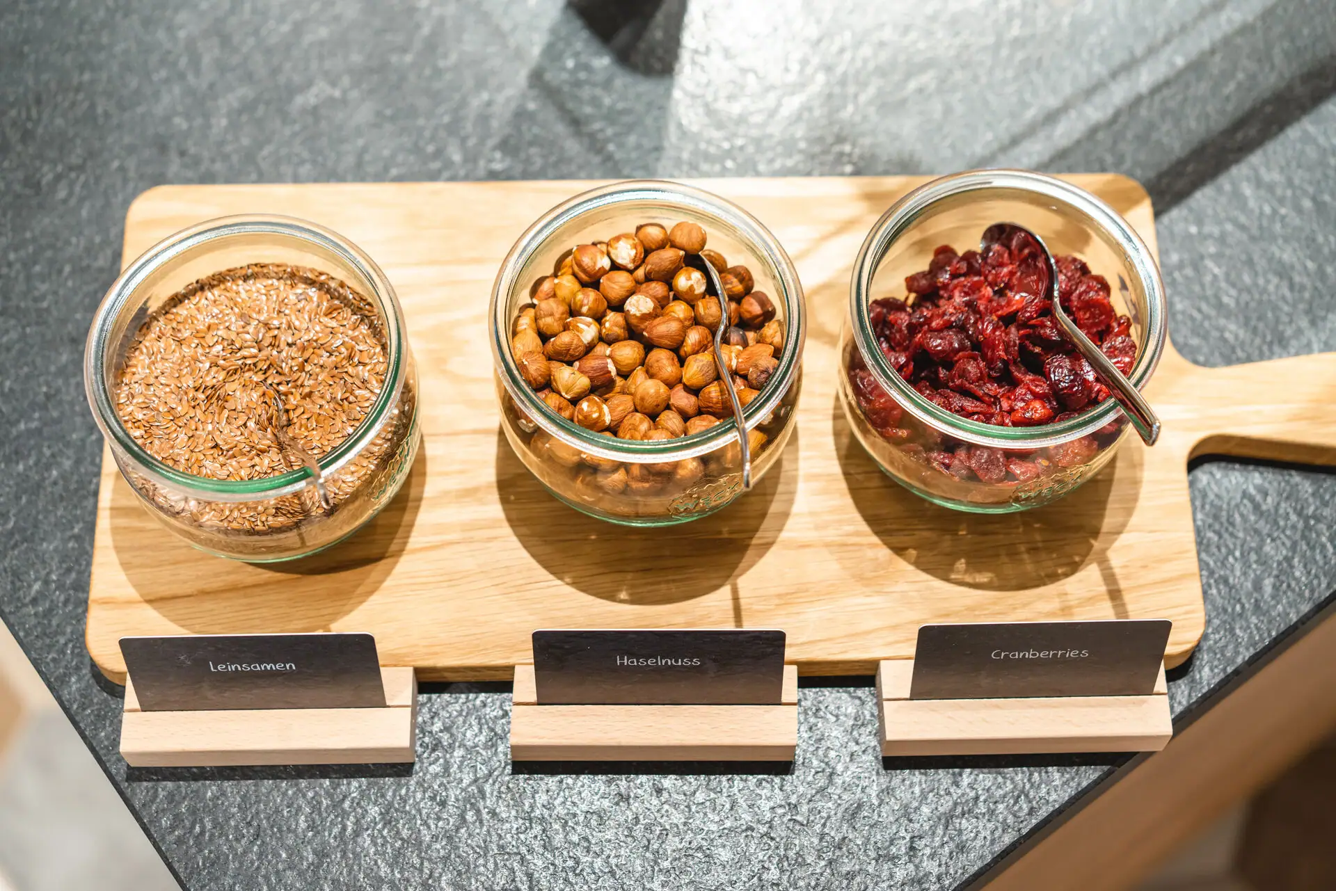 Müsli Eine Gruppe von Schalen mit Essen auf einem Holzbrett.