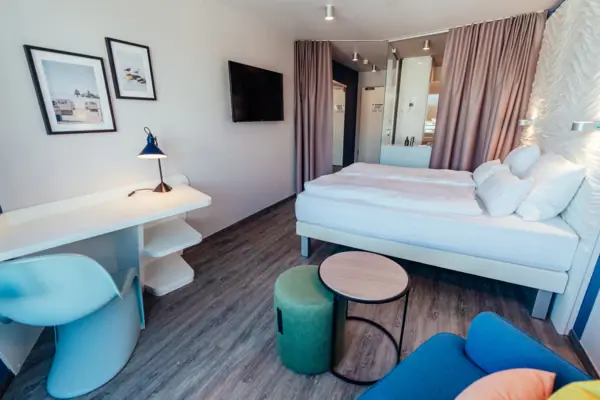 Ein Zimmer mit einem Bett, einem Tisch und einem Stuhl.