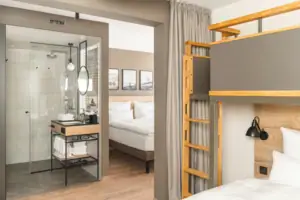 Familienzimmer Ein Zimmer mit einem Bett und einer Dusche.