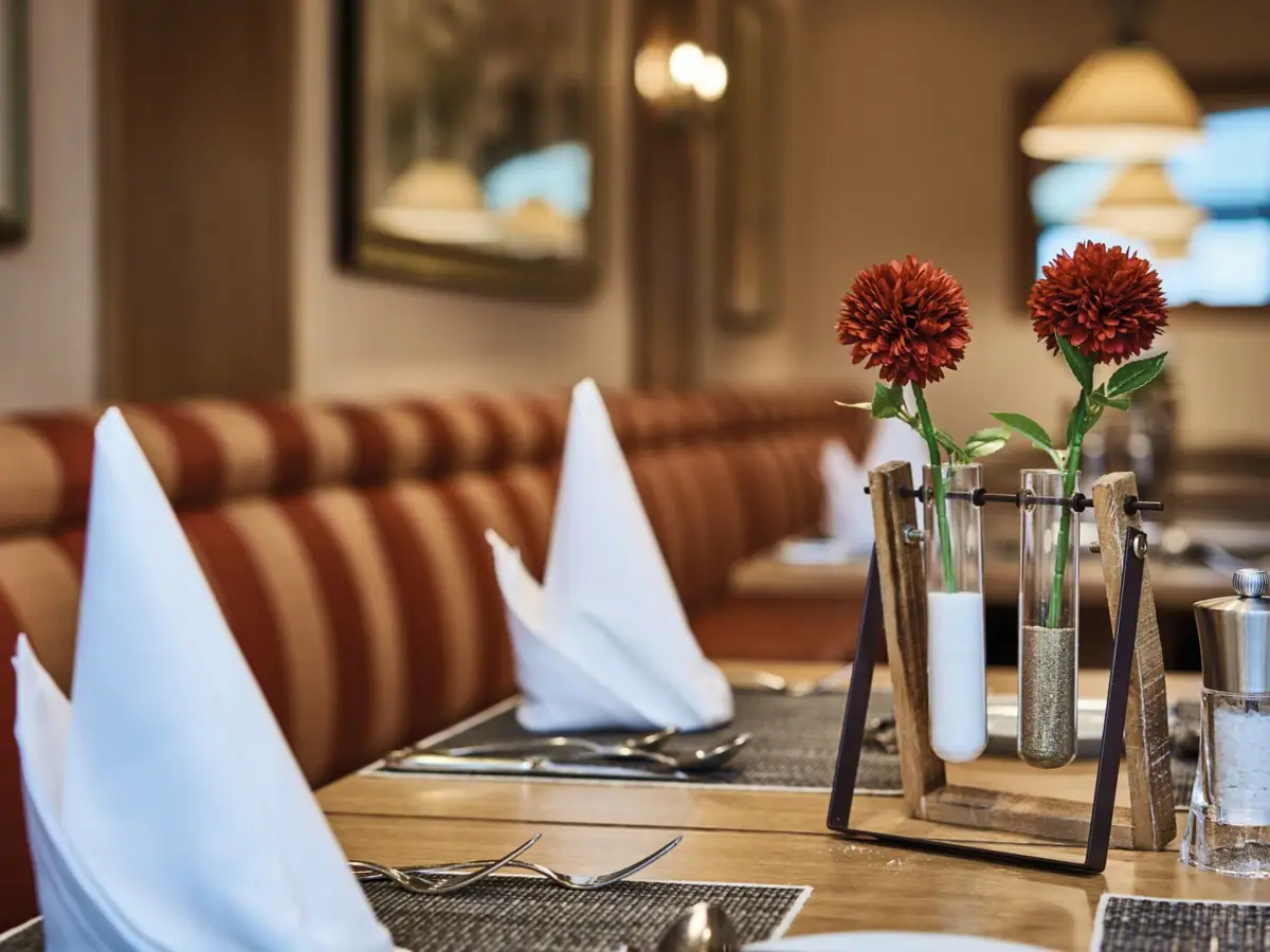 Restaurant Flora Ein Tisch mit ein paar Vasen mit Blumen.