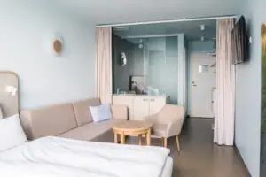 Doppelzimmer  Ein Zimmer mit einem Sofa und einem Tisch.