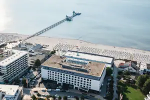 Luftaufnahme eines Strandes mit angrenzenden Gebäuden.
