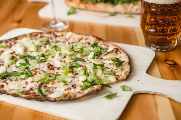 Flammkuchen auf einem Schneidebrett